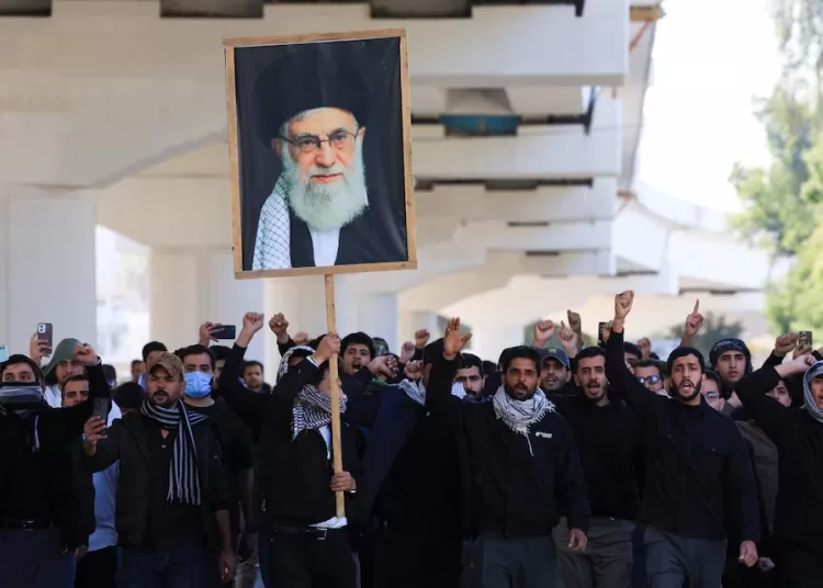 Protesters supporting Iraqi Shi'ite armed groups demonstrate near the entrance of the Green Zone after the killing of Iran's Supreme Leader Ayatollah Ali Khamenei, in Baghdad, Iraq, March 1, 2026.