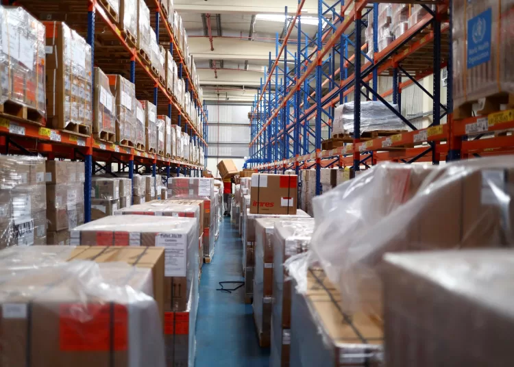 A contractor moves a World Health Organization (WHO) humanitarian relief box ahead of flights sponsored by the International Humanitarian City (IHC) to Turkey and Syria which were devastated by an earthquake, in Dubai, United Arab Emirates, February 7, 2023. REUTERS/Amr Alfiky/File Photo