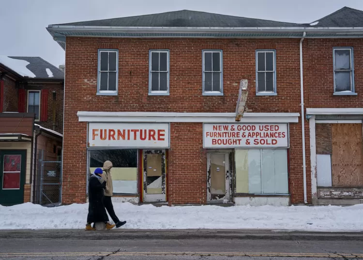 Pedestrians walk past a derelict furniture store in Springfield, Ohio, U.S., February 4, 2026. REUTERS
