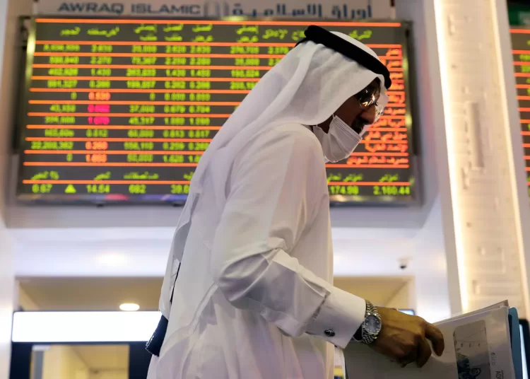 An investor walks through the Dubai Financial Market in Dubai, United Arab Emirates November 8, 2020.