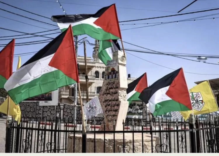 Palestinian flags flutter at the ‘The Martyrs’ Monument’ in Abu Falah, northeast of Ramallah, in the Israeli-occupied West Bank on March 12, 2026. (AFP)