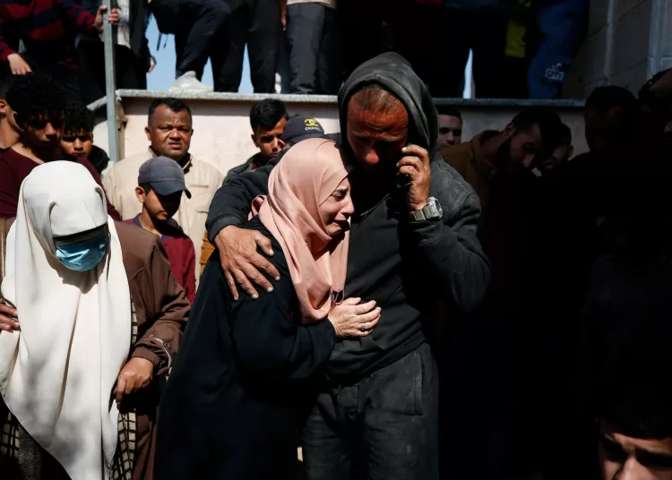 Mourners react next to the bodies of Palestinians killed in an Israeli strike, in the northern Gaza Strip March 15, 2025. REUTERS/