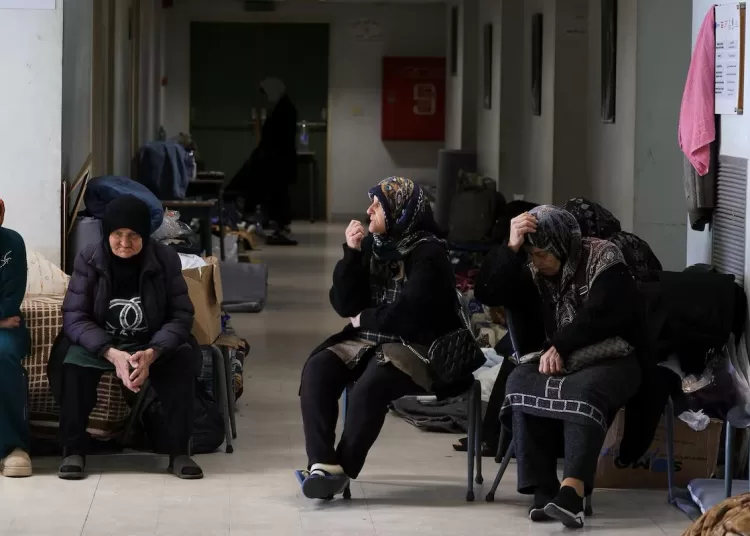 Women sit in a school turned shelter for people displaced from Beirut's southern suburbs and southern Lebanon, following an escalation between Hezbollah and Israel amid the U.S.-Israeli conflict with Iran, in Beirut, Lebanon, March 11, 2026. REUTERS