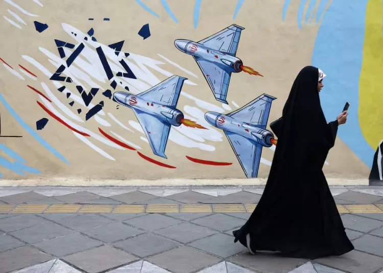 US seizes tanker in international waters 11 - Egyptian Gazette A woman walks next to an anti-Israeli mural on a street, amid a ceasefire between U.S. and Iran, in Tehran, Iran, April 20, 2026. Reuters