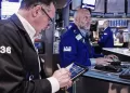 Wall Street inches higher while oil prices fall