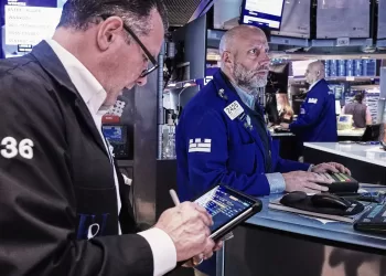 Wall Street inches higher while oil prices fall