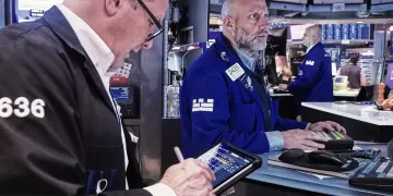 Wall Street inches higher while oil prices fall
