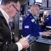 Wall Street inches higher while oil prices fall
