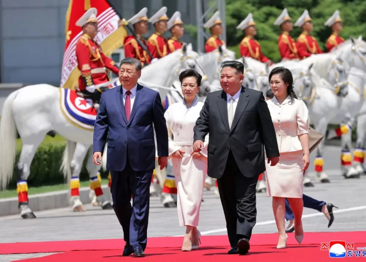 In this photo provided by the North Korean government, Chinese President Xi Jinping, left, and his wife Peng Liyuan, second left, accompanied by North Korean leader Kim Jong Un, second right, and his wife his wife Ri Sol Ju, attend a welcome ceremony in Pyongyang, Monday, June 8, 2026. (Korean Central News Agency/Korea News Service via AP)