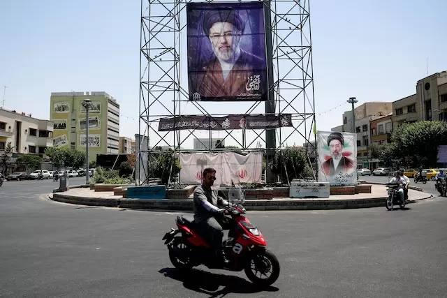 US, Iran negotiators head to Doha with talks in doubt 9 - Egyptian Gazette People ride past a banner with a picture of Iran's Supreme Leader, Mojtaba Khamenei, in Tehran, Iran, June 28, 2026.