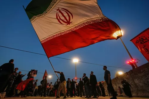 Who hit Iran? Unclaimed strikes follow US attacks 12 - Egyptian Gazette A man waves an Iranian flag during funeral ceremonies for slain Iranian Supreme Leader Ayatollah Ali Khamenei and members of his family at Imam Khomeini Mosalla Grand Mosque in Tehran, Iran, Sunday, July 5, 2026.