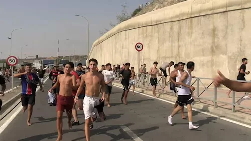 Spain, Morocco move to stop mass enclave crossings 12 - Egyptian Gazette Migrants run and cheer as they cross on foot into the North African enclave of Ceuta from Morocco, after swimming over from the Moroccan side and overwhelming police at the city’s breakwater, according to Spain’s Guardia Civil, in Ceuta, Spain, July 30, 2026