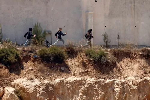 Israel urges police to replace military for West Bank settlers 11 - Egyptian Gazette Israeli settlers run as being chased by an Israeli military vehicle around Palestinian houses in the village of Qusra, south of Nablus, in the occupied West Bank, on August 13, 2026. (FILE/AFP)