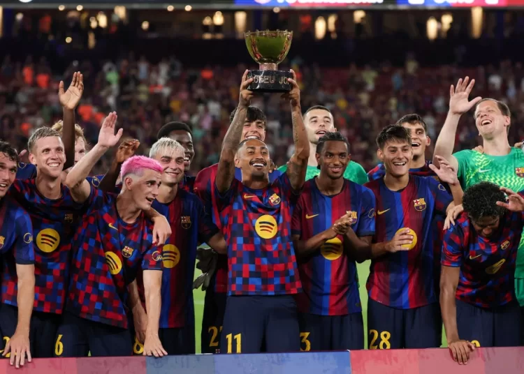 Barcelona's Brazilian forward #11 Raphinha (C) holds the trophy after Barcelona won the 61st Joan Gamper Trophy football match between FC Barcelona and Al Ahly FC at the Camp Nou Stadium in Barcelona on August 19, 2026. (Photo by Lluis GENE / AFP)