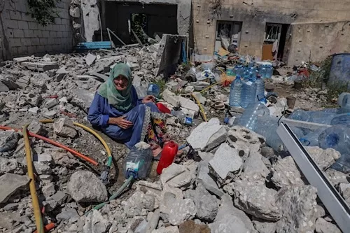 Israel-Lebanon talks resume Wednesday 11 - Egyptian Gazette Khadija Amara, whom local residents said had not left her home, fills a jerrycan with water as she sits among the rubble of a house, which was damaged by an Israeli strike, in Qlaileh in the Tyre district, southern Lebanon, June 19, 2026. REUTERS/Zohra Bensemra TPX IMAGES OF THE DAY
