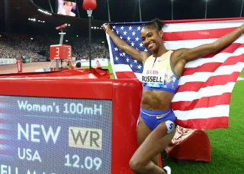 Russell shatters 100m world record