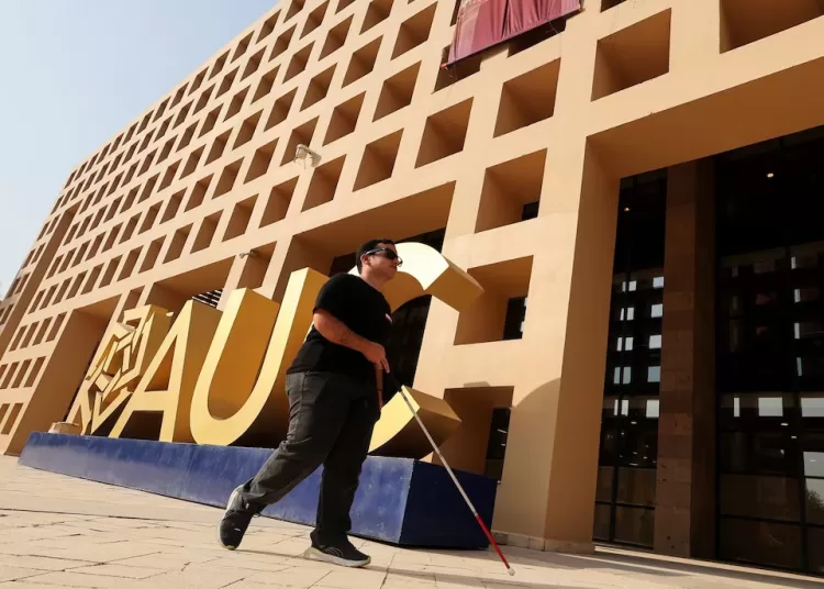 Blind Egyptian entrepreneur’s AI helps others see 12 - Egyptian Gazette Mark Morad, 20, an Egyptian student, entrepreneur and developer of the AI-powered Scribeme application, walks with a cane past the American University in Cairo (AUC) logo in Cairo, Egypt, August 12, 2026. REUTERS