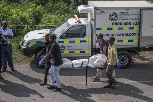 27 killed in South Africa mass shootings 12 - Egyptian Gazette South African forensic pathology personnel are assisted by community members to carry the body of a victim following a mass shooting in the Ziko area of KwaMakhutha, south of Durban on September 23, 2026. (AFP)