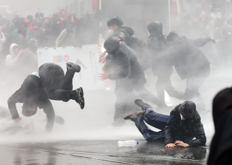 Germany's firewall against the far-right AfD feels the heat 11 - Egyptian Gazette Demonstrators react to police water cannons as student protesters join a nationwide strike against the Belgian government's austerity measures and budget cuts, in Brussels, Belgium, October 9, 2026. REUTERS/Yves Herman