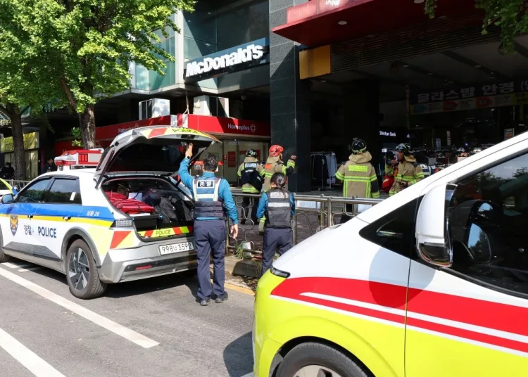 Police officers and firefighters arrive at the scene after a stabbing incident at a supermarket in Incheon. (AFP)